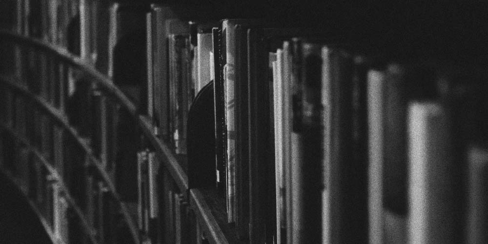 Black and white photo of shelves full of books