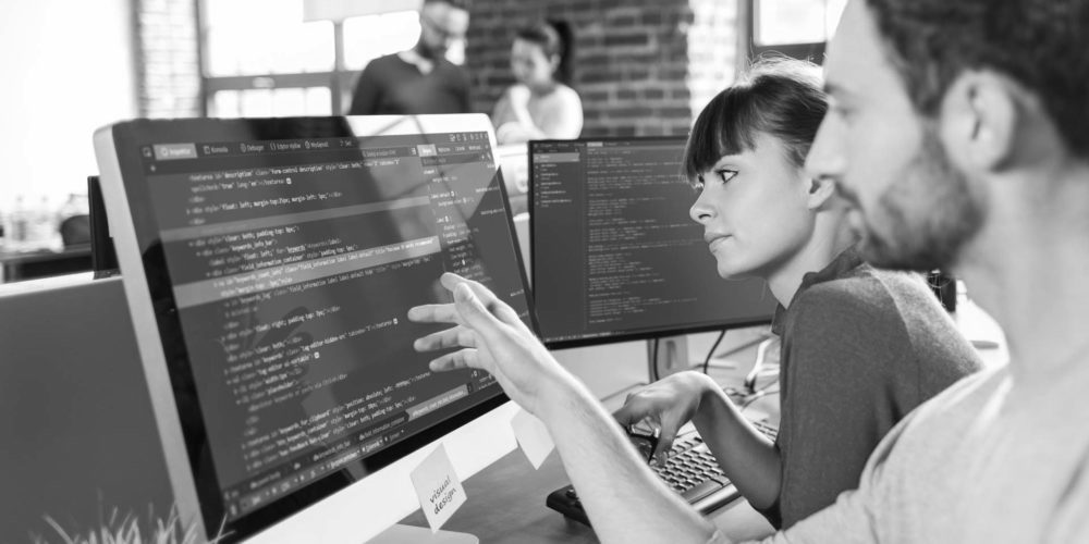 Man and woman working together at computer